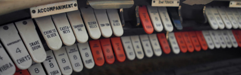 an image of red and white buttons controlling an old organ