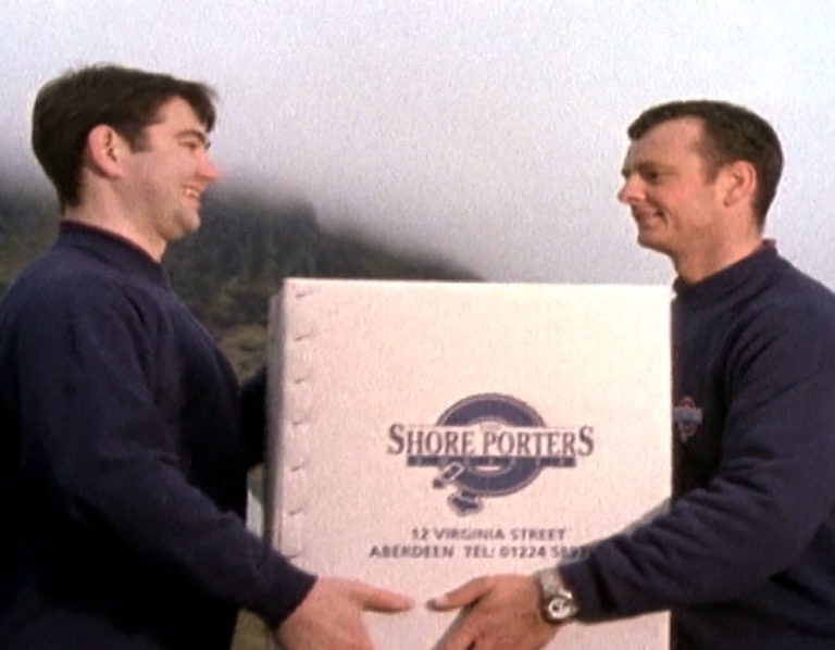 a delivery man giving a large package to a recipient