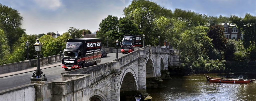 moving truck crossing a city bridge