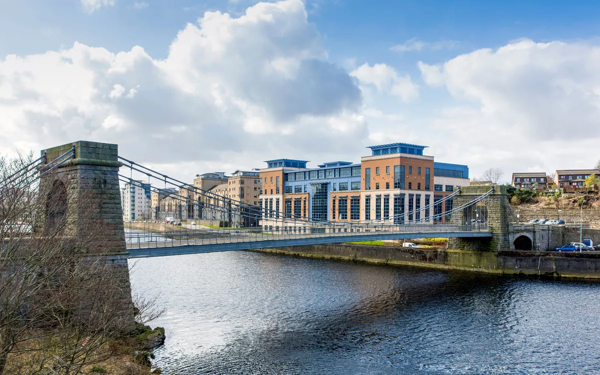 Modern riverside office buildings beside the Wellington Suspension Bridge in Aberdeen