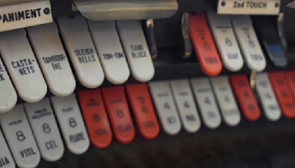 an image of red and white buttons controlling an old organ